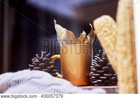Corns, Autumn Leaves, Pine Cones And Coffee Cup On Windowsill. Creative Autumnal Background Near The