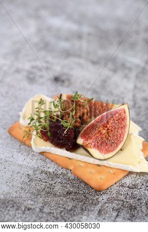 Cracker With A Slice Of Camembert, Jam, Figs And Nuts.
A Great Snack Idea For A Holiday, Picnic Or P