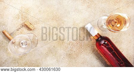 Rose Wine Glass With Bottle On The Beige Table. Copy Space, Top View