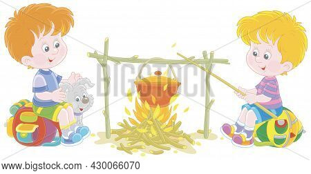 Little Boy-scouts With A Small Pup In A Forest Camp, Friendly Smiling, Talking And Cooking Tasty Sou