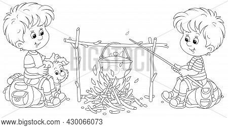 Little Boy-scouts With A Small Pup In A Forest Camp, Friendly Smiling, Talking And Cooking Tasty Sou