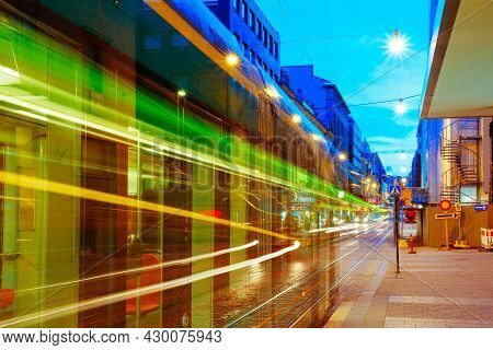 Helsinki, Finland. Tram Departs From A Stop On Street Aleksanterinkatu In Helsinki. Night View Of Al