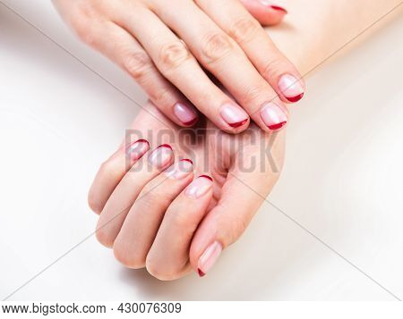 Female Hands With A Trendy Autumn French Manicure