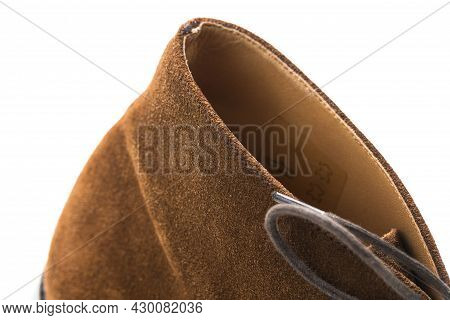 Closeup Of Texture Of Brown Suede Mens Shoes Over White Background