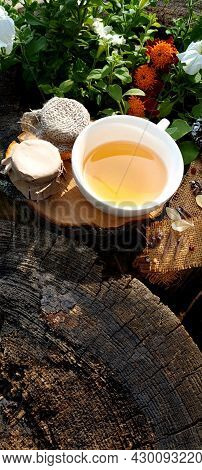 Two Jars Of Jam, Cup Of Tea From The Berries Of Viburnum, Lemon And Honey, On Background Of Wooden T