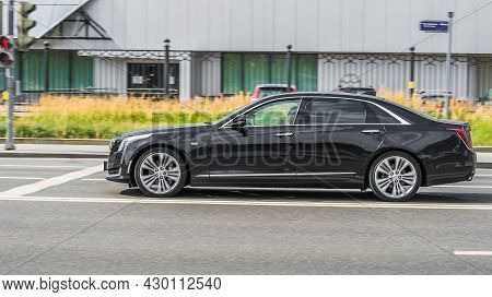 Cadillac Ct6 In Motion, Side View. Photography Of A Modern Premium Sedan Driving On Street In Moscow