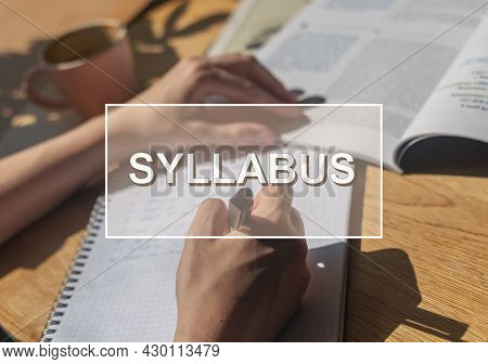 Syllabus Word Over Photo With Hand Closeup Writing In Notebook.