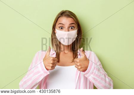 Concept Of Quarantine, Coronavirus And Lifestyle. Close-up Of Excoted Attractive Girl In Face Mask, 