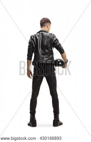 Full length rear view shot of a biker in a leather jacket holding a helmet isolated on white background