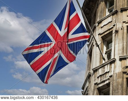 Londonunited Kingdom; 07172015: Uk Flag Waving On A Building On Blue Sky Background With White Cloud