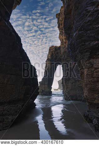 Arch-shaped Rock Formation On Las Catedrales Beach In Galicia In Spain.