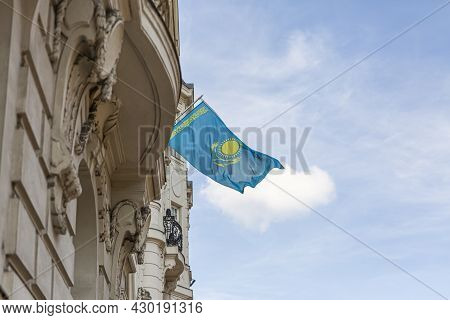 Kazakhstan Flag Agains Blue Sky. Kazakhstan Flag Hanging On A Pole In Front Of The House. National F