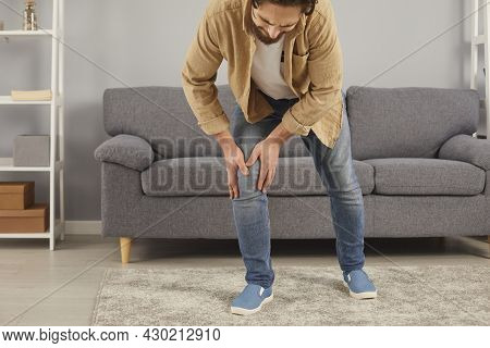 Young Man Who Has Arthritis Or Rheumatism Tries To Walk But Feels Pain In His Knee