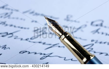Fountain Pen On Paper With Ink Text On The Paper Closeup