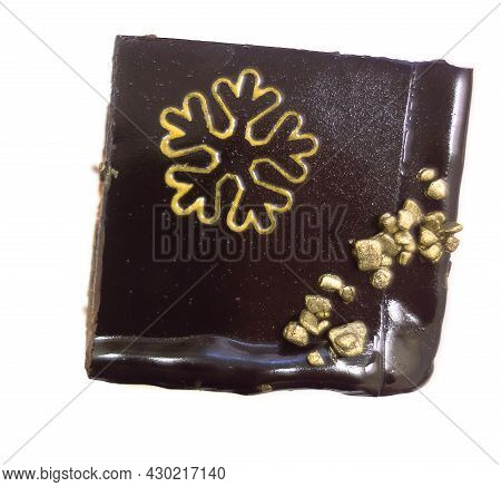 A Piece Of Cake Poured Over With Chocolate On Which A Snowflake Is Drawn. Isoplated On White. Flat L