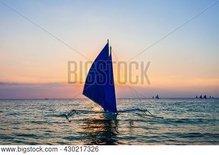 Traditional Filipino Boat At The Idyllic White Sand Beach At Boracay Island In Philiphines At Sunset