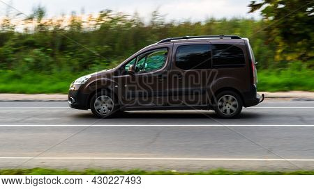 Moscow, Russia - August 2021: Brown Lav Peugeot Partner Fast Speed Driving On The Country Road