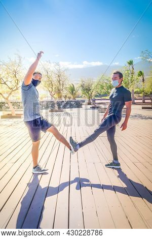 Covid-19 Pandemia Greeting With Legs American Man And Caucsian Man