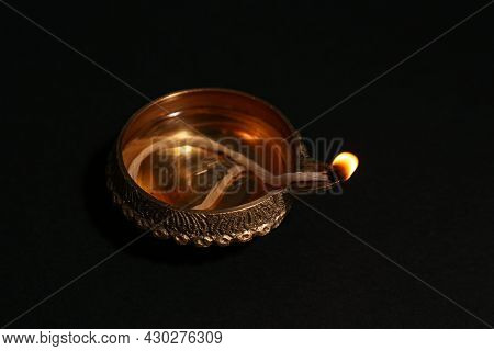 Lit Diya On Dark Background, Closeup. Diwali Lamp