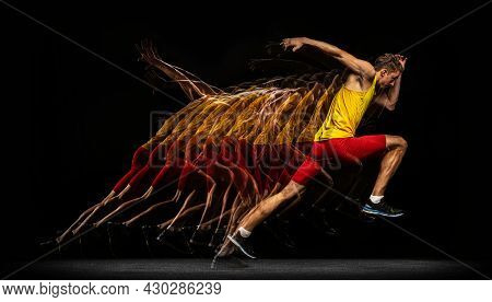 Portrait Of Young Man, Professional Male Athlete, Runner In Motion And Action Isolated On Dark Backg