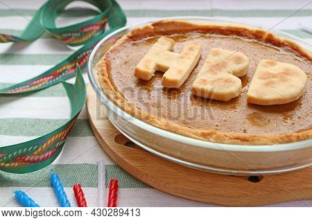 Delectable Fresh Baked Pumpkin Pie Topped With Hbd Alphabets For Birthday Celebration