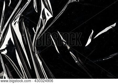 Wrinkled plastic wrap texture on a black background wallpaper