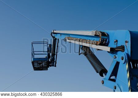Telescopic Boom Lift On Blue Sky Background Delivered To Constraction Site