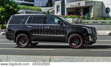 Black Luxury Cadillac Escalade In The Traffic Of The City. Moscow, Russia - July 2021