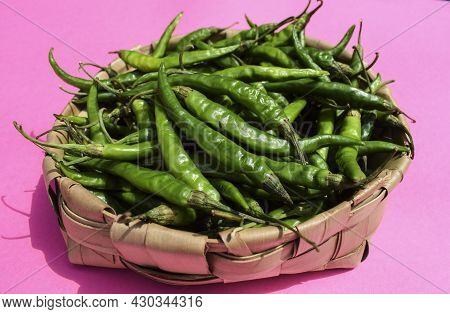 Freshly Plucked Spicy Hot Dark Green Chillies In Basket. Organic Green Peppers Harvest In Wicker Bas