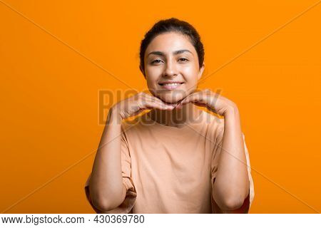 Close Up Portrait Of Young Indian American Woman Touching Face Skin Her Hands And Doing Self Yoga Fa