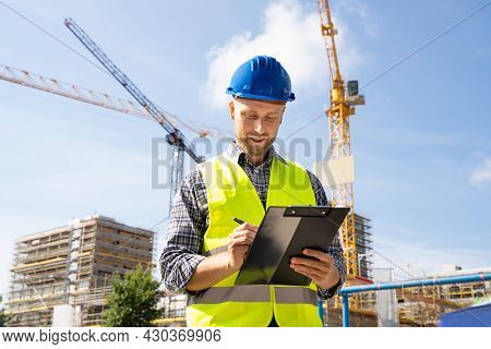 Osha Inspector At Construction Site. Young Engineer Worker