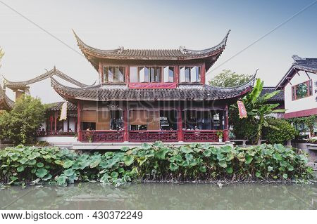 Shanghai, China - September 2019: Traditional Chinese Teahouses And Buildings Along The Riverbank Of