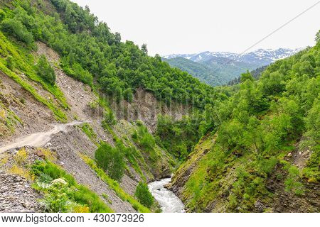 Amazing View Of The Landslide On A Mountain Road. Mountain Dirt Road Through The Gorge Along The Mou
