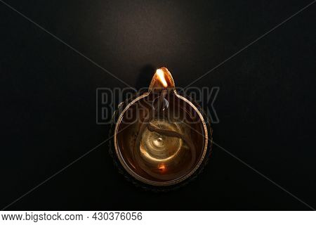 Lit Diya On Dark Background, Top View. Diwali Lamp