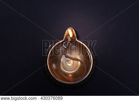 Lit Diya On Dark Background, Top View. Diwali Lamp