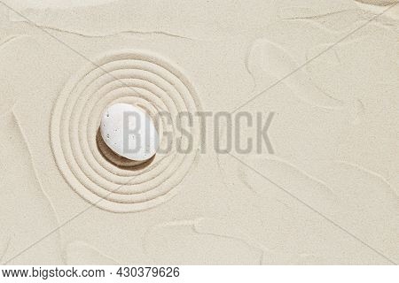 Aesthetic Minimal Background With Zen Stone On Sand. Pattern In Japanese Zen Garden With Concentric 
