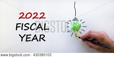 2022 Fiscal New Year Symbol. Businessman Writing Words '2022 Fiscal Year', Isolated On Beautiful Whi