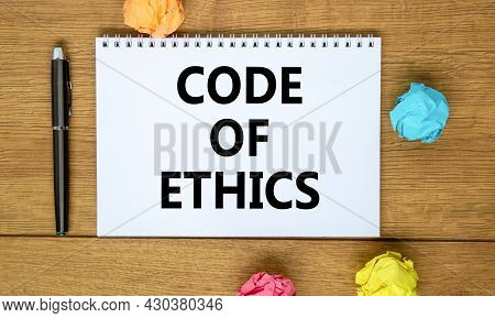 Code Of Ethics Symbol. Words 'code Of Ethics' On Beautiful Wooden Table, Colored Paper, Black Metall