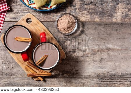 Traditional Mexican Chocolate Atole Drink On Wooden Table. Top View. Copy Space