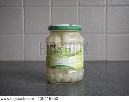 Sint Gillis Waas, Belgium, 20 August 2021, A Glass Jar Of Silver Onions In Vinegar Of The Brand Name