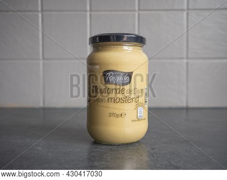 Sint Gillis Waas, Belgium, August 20, 2021, A Glass Jar Of Dijon Mustard Under The Brand Name Regalo