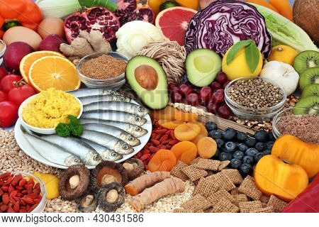 Healthy immune system boosting low cholesterol food high in antioxidants, protein, omega 3, vitamins, minerals, lycopene, anthocyanins, fibre. Natural health care concept.