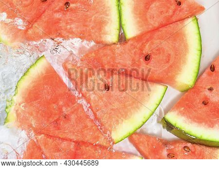 Slices Of Melon In Water On White Background. Melon Close-up In Liquid With Bubbles. Slices Of Red R
