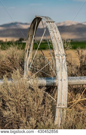 Three Quarter View Of Single Irrigation Wheel Stuck In The Weeds Outside Of Great Basin National Par