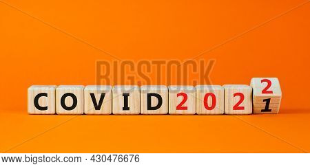Symbol Of Covid-19 Pandemic In 2022. Turned A Wooden Cube And Changed Words 'covid 2021' To 'covid 2