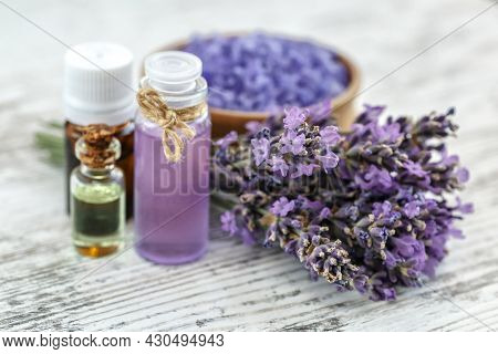 Lavender's Spa Products With Dried Lavender Flowers On A Wooden Table. Flat Lay Bath Salt And Massag