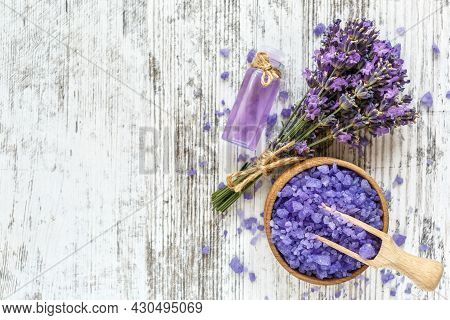 Lavender's Spa Products With Dried Lavender Flowers On A Wooden Table. Flat Lay Bath Salt And Massag