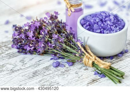 Lavender's Spa Products With Dried Lavender Flowers On A Wooden Table. Flat Lay Bath Salt And Massag