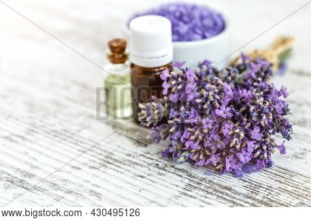 Lavender's Spa Products With Dried Lavender Flowers On A Wooden Table. Flat Lay Bath Salt And Massag