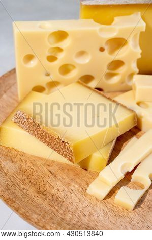 Cheese Collection, Hard French Cheeses Comte And Emmentaler With Round Holes Made From Cow Milk